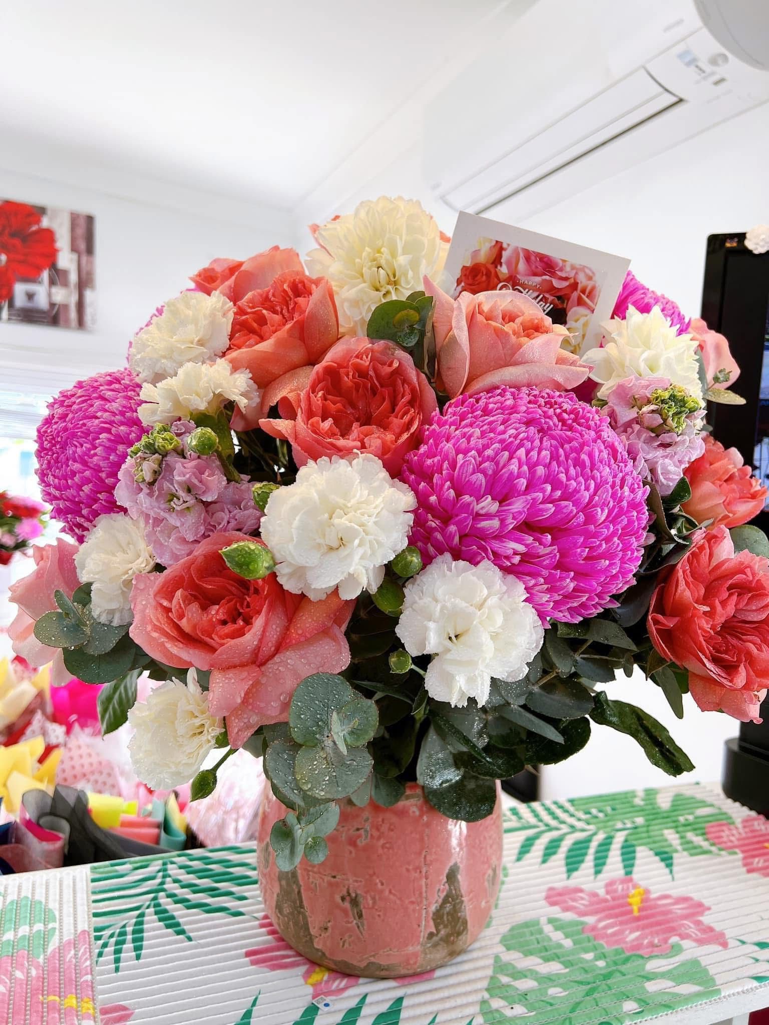 Pink, coral and white mixed flower arrangement in a vase