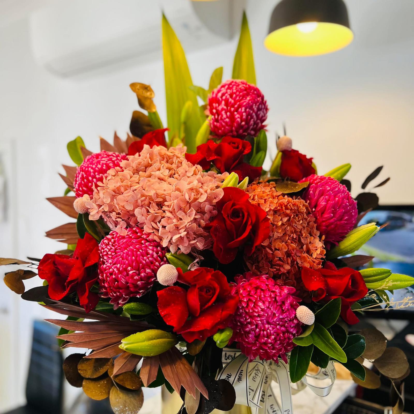 Bold red pink and peach floral arrangement